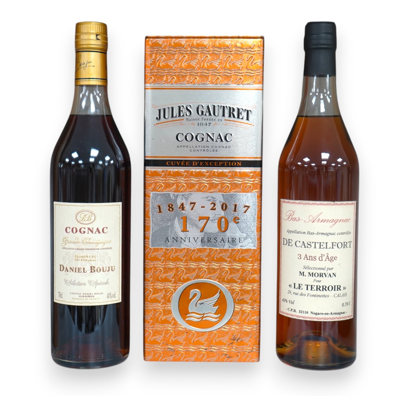 Three bottles of cognac/armagnac - a cased bottle of Jules Gautret 170th anniversary cognac, a bottle of Daniel Bouju Selection Speciale Grand Champagne Cognac and a bottle of De Castelfort Bas Armagnac. Condition - good